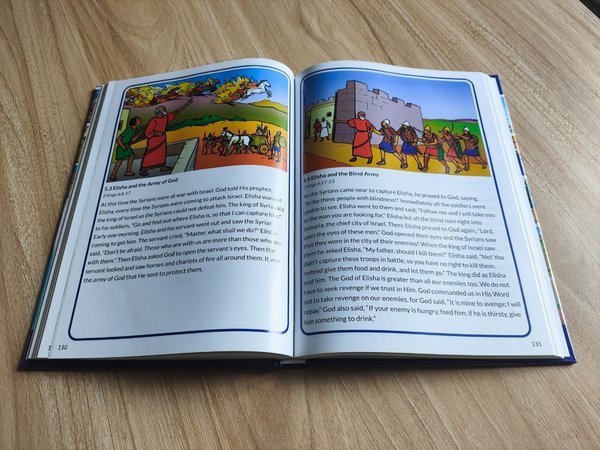Hardcover lying flat showing full color interior pages Hardcover lying flat showing full color interior pages