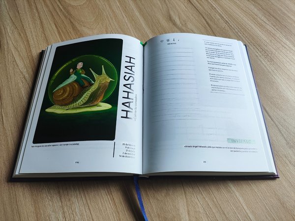 Hardcover lying flat showing full color interior and bound ribbon marker Hardcover lying flat showing full color interior and bound ribbon marker